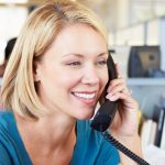 Young female on the phone in office branch